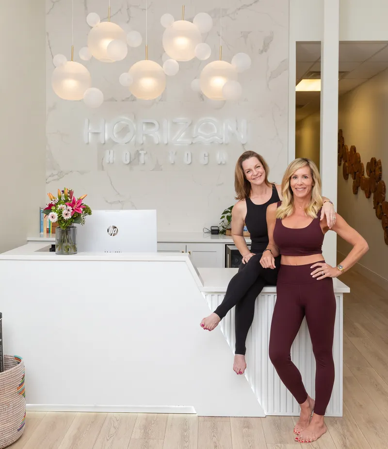 Quinn Ray and Mary Ellen Crow at the Horizon Hot Yoga front desk